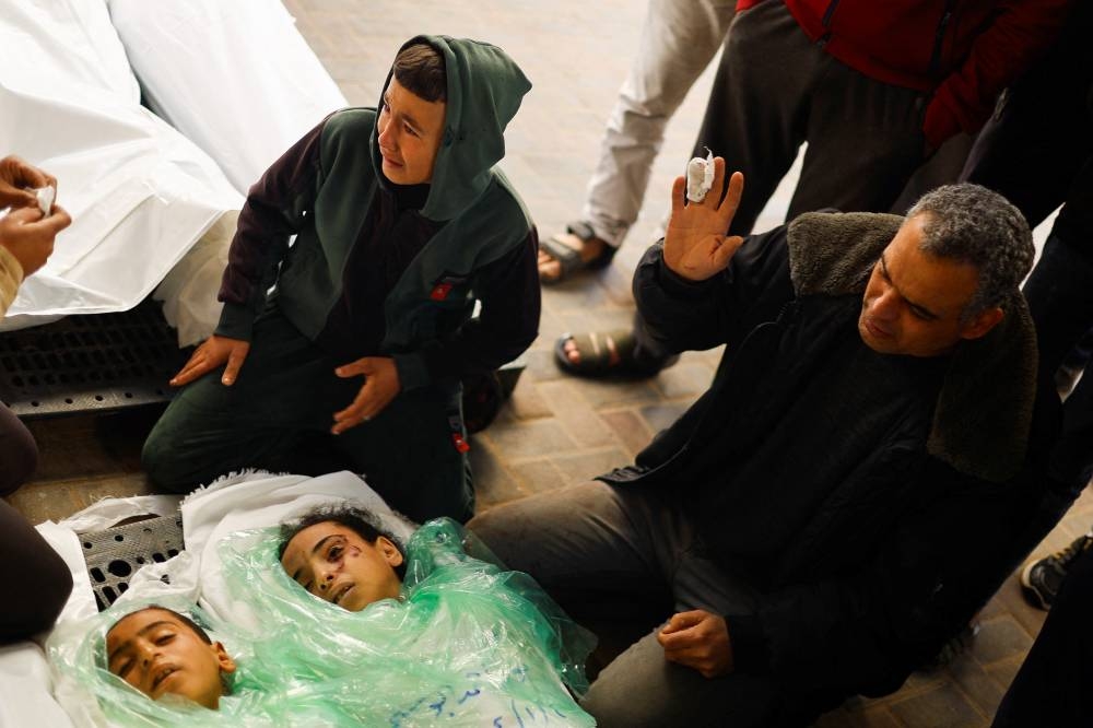 Father of Yousef and Noura Abu Sanjar, reacts next to their bodies after they were killed in an Israeli strike at Abu Yousef Al Najjar hospital, in Rafah, in the southern Gaza Strip, on Friday. REUTERS