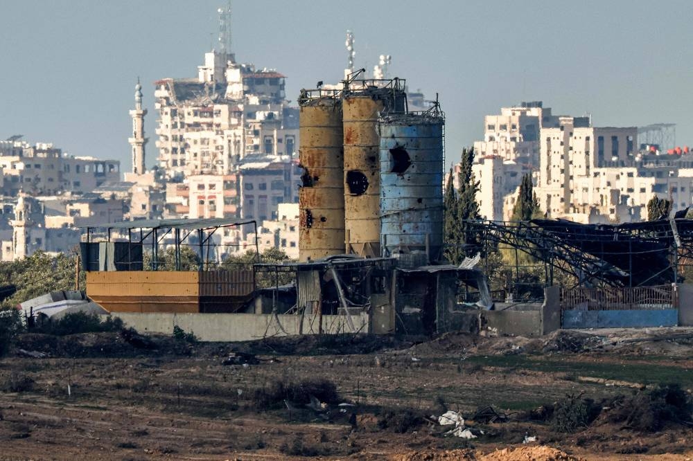 Silos damaged by Israeli bombardment in the Gaza Strip are pictured from a position along the border in southern Israel. AFP