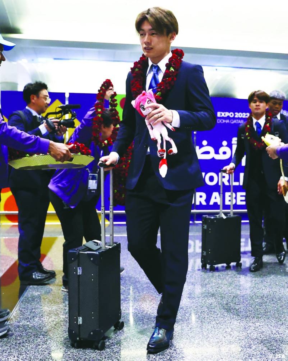 Japan players arrive at the Hamad International Airport on Friday.
