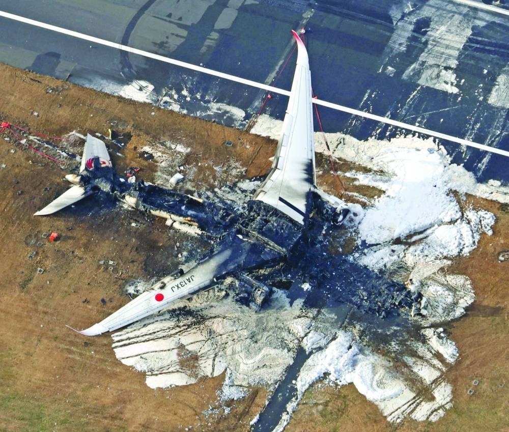 
An aerial view shows burnt Japan Airlines’ (JAL) Airbus A350 plane after a collision with a Japan Coast Guard aircraft at Haneda International Airport in Tokyo on Wednesday. 