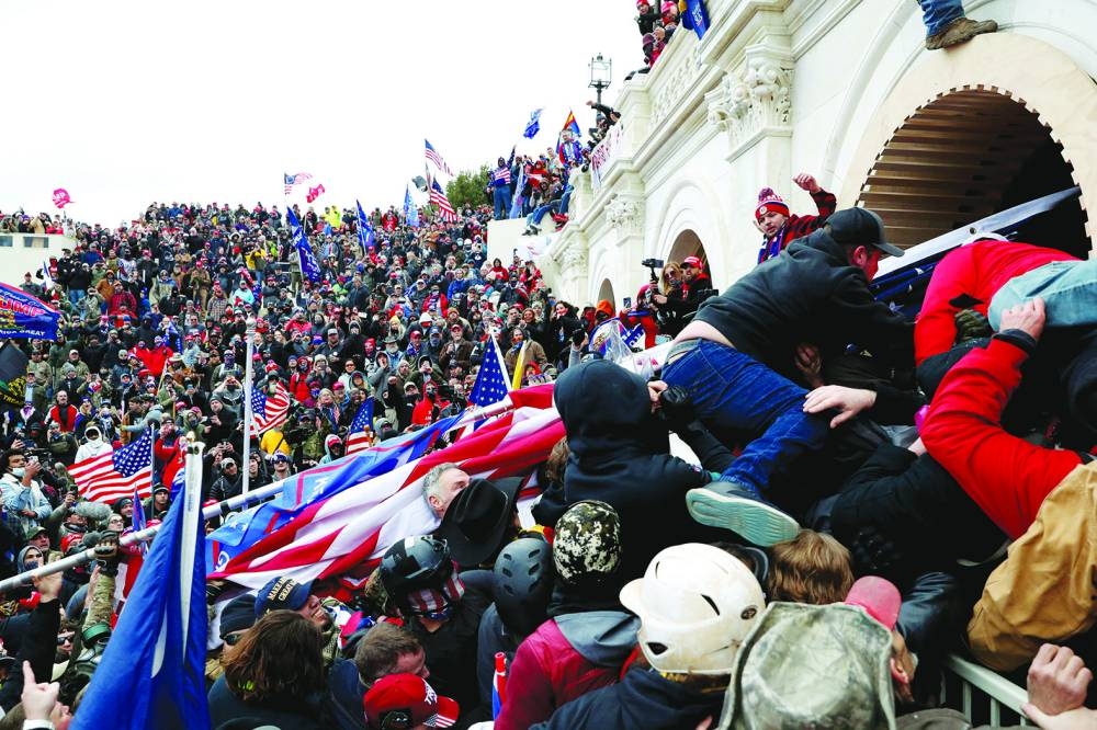 FILE PHOTO: Pro-Trump protesters storm into the US Capitol during clashes with police, during a rally to contest the certification of the 2020 US presidential election results by the US Congress, in Washington, on January 6, 2021.