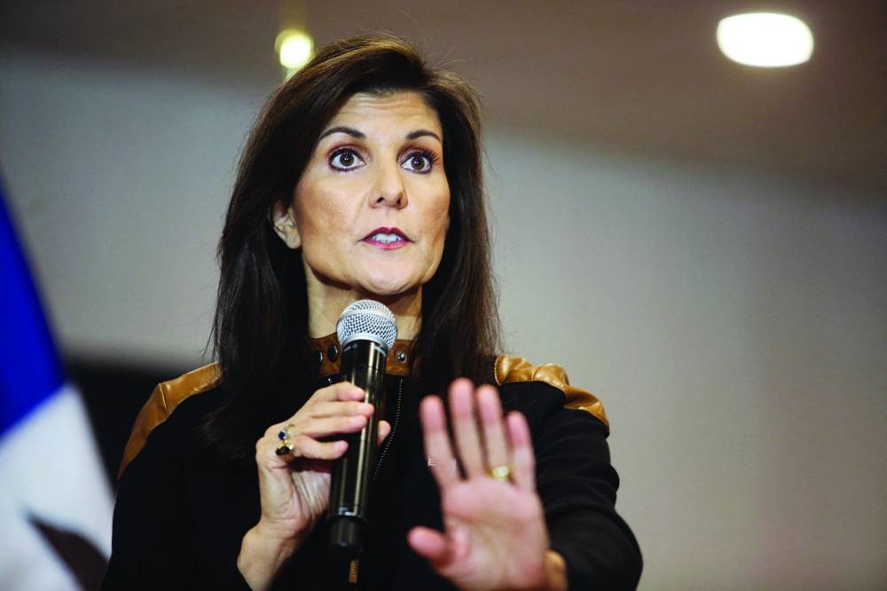 
FILE PHOTO: Republican presidential candidate and former US president Donald Trump attends a campaign event in Waterloo, Iowa, on December 19, 2023. FILE PHOTO Pro-Trump protesters storm into the US Capitol during clashes with police, during a rally to contest the certification of the 2020 US presidential election results by the US Congress, in Washington, on January 6, 2021.  