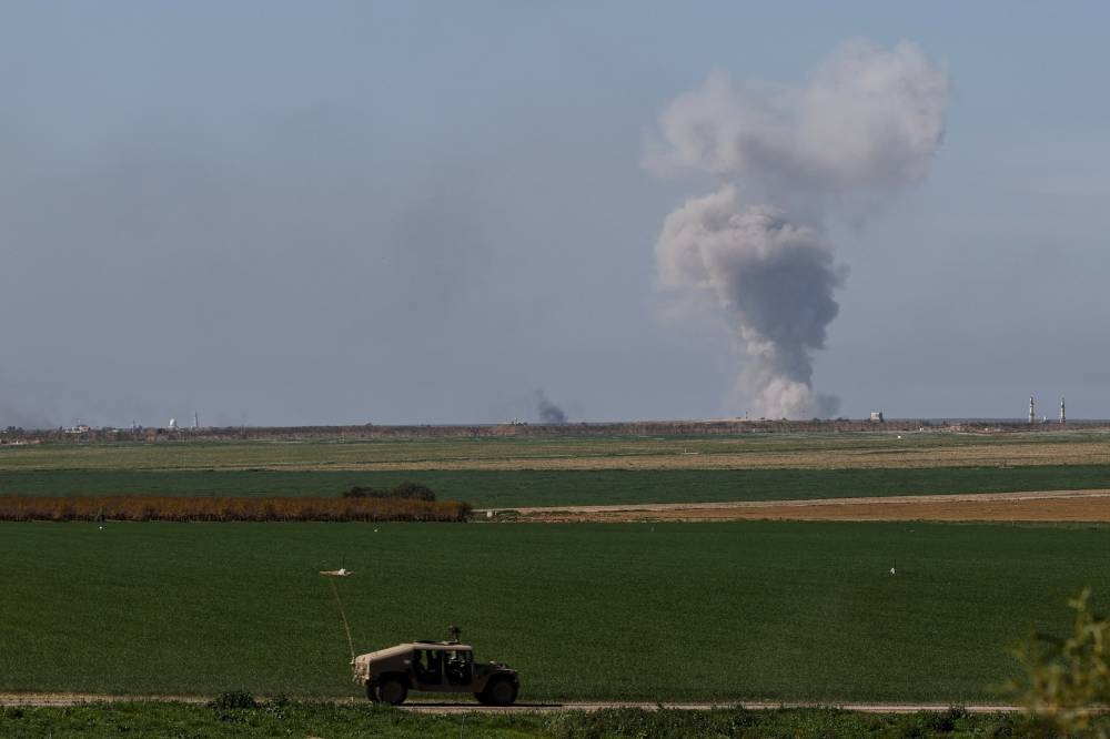 An Israeli military vehicle drives along near the Israel-Gaza border in southern Israel on Saturday. REUTERS