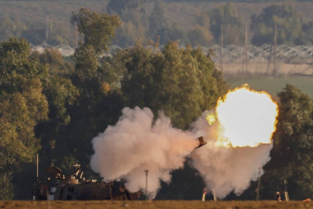 An Israeli artillery unit fires near the Israel-Gaza border, in southern Israel on Saturday. REUTERS