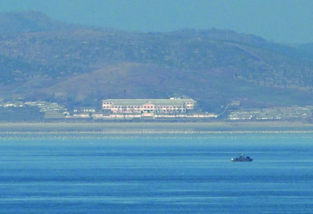 
A general view shows an unidentified boat before the North Korean coastline as seen from a viewpoint on Yeonpyeong island, near the ‘northern limit line’ sea boundary with North Korea. 