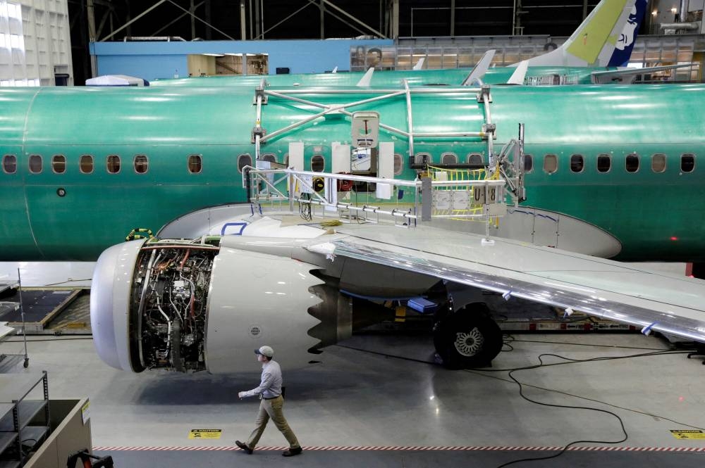 A worker walks past Boeing's new 737 MAX-9 under construction at their production facility in Renton, Washington, US, February 13, 2017. REUTERS/Jason Redmond/File Photo