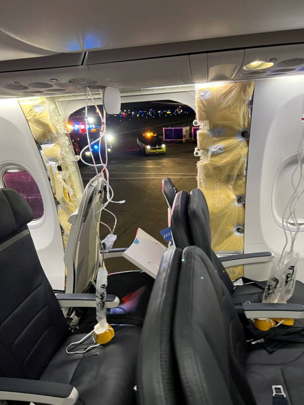 Passenger oxygen masks hang from the roof next to a missing window and a portion of a side wall of an Alaska Airlines Flight 1282, which had been bound for Ontario, California and suffered depressurization soon after departing, in Portland, Oregon, US on Friday. Instagram/@strawberrvy via REUTERS