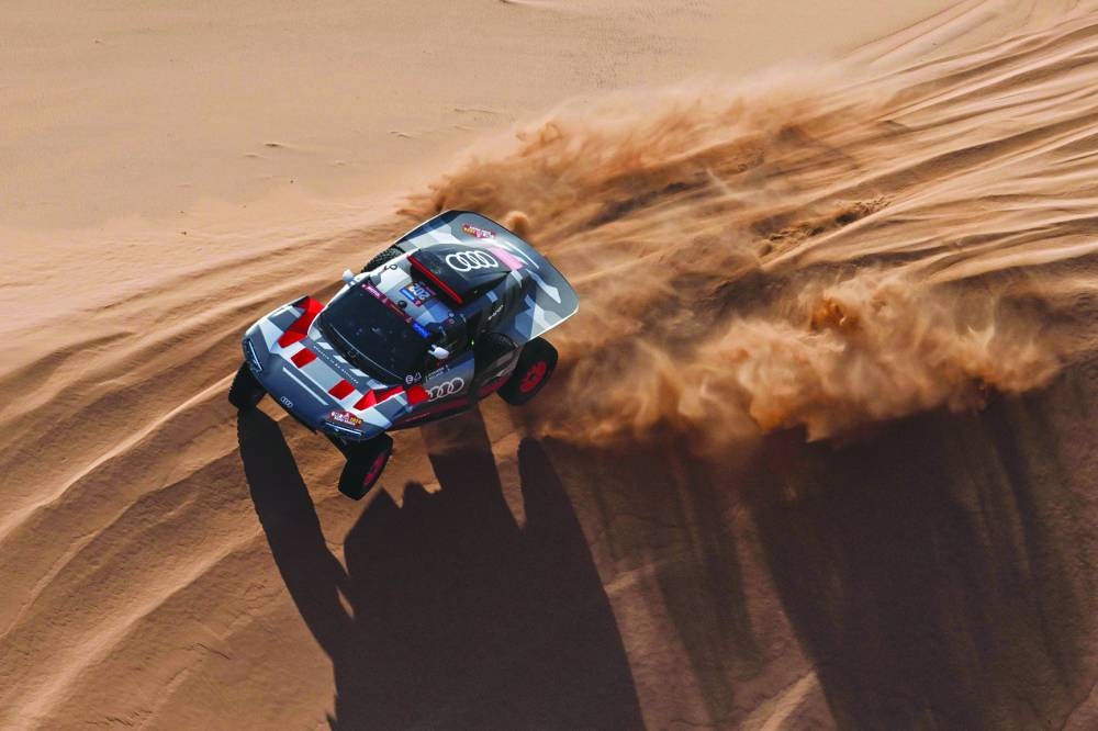 Team Audi Sport's French driver Stephane Peterhansel and French co-driver Edouard Boulanger steer their car during stage 2 between Al Henakiyah and Al Duwadimi, Saudi Arabia, yesterday as part of the Dakar Rally 2024. (AFP)