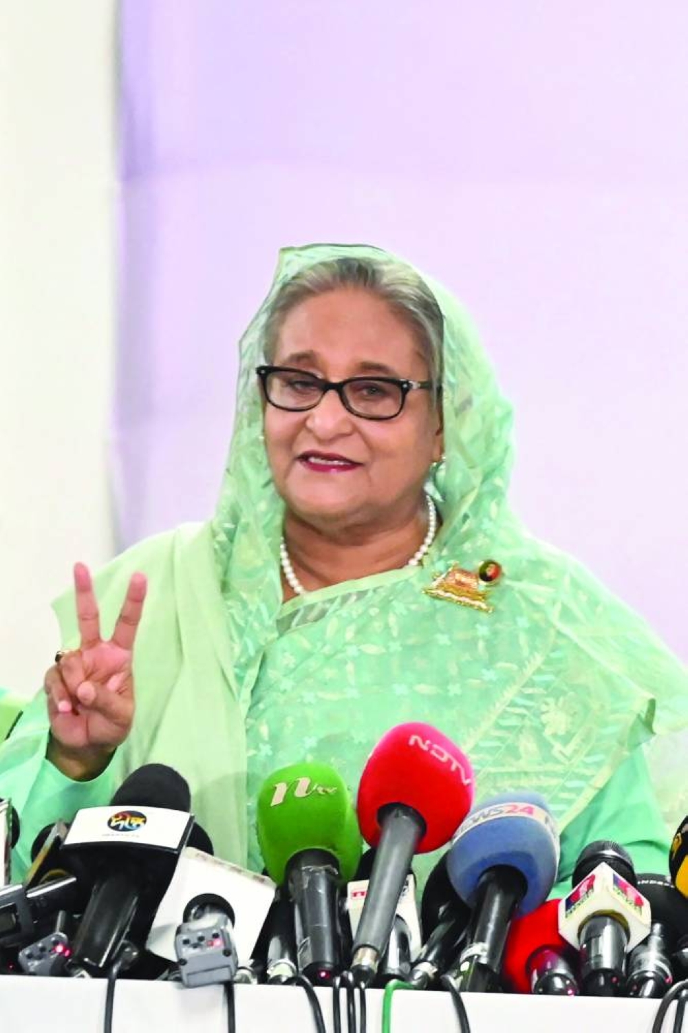 
Prime Minister Sheikh Hasina gestures after casting her vote at a polling station in Dhaka. 