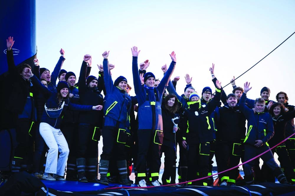 French skipper Tom Laperche (centre) waves as he leaves aboard his multihull SVR- Lazartigue to take the start of the multihull 
around-the-world solo sailing race Arkea Ultim Challenge, in Brest, yesterday. Right: French skipper Armel Le Cleac’h sails his Banque Populaire Ultim multihull after the start of the Arkea Ultim Challenge. (AFP)
