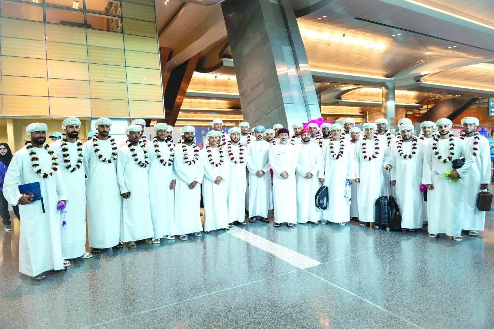 Oman players pose after their arrival at the Hamad International Airport on Monday.