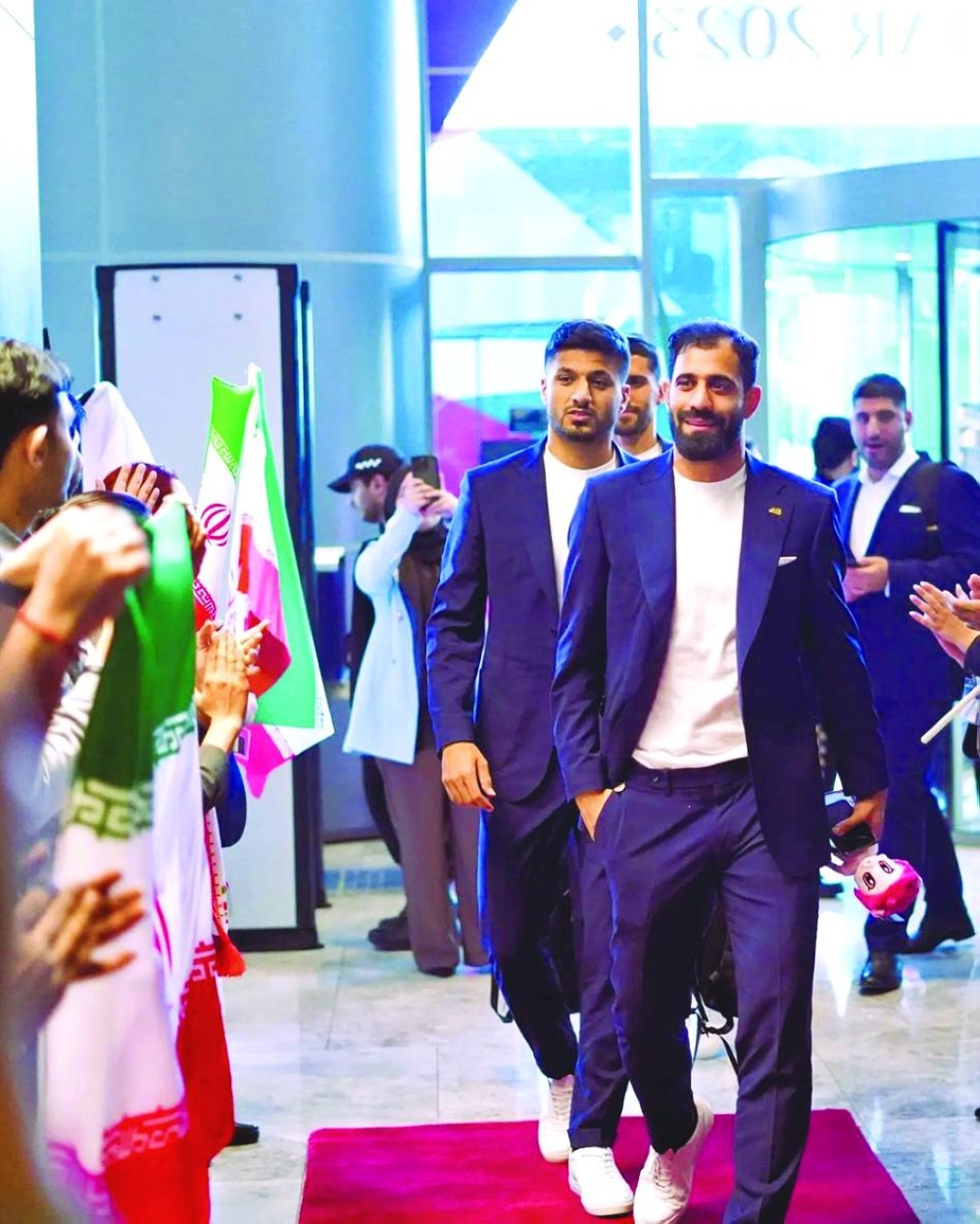 Iran players are greeted as they check into a hotel in Al Rayyan.