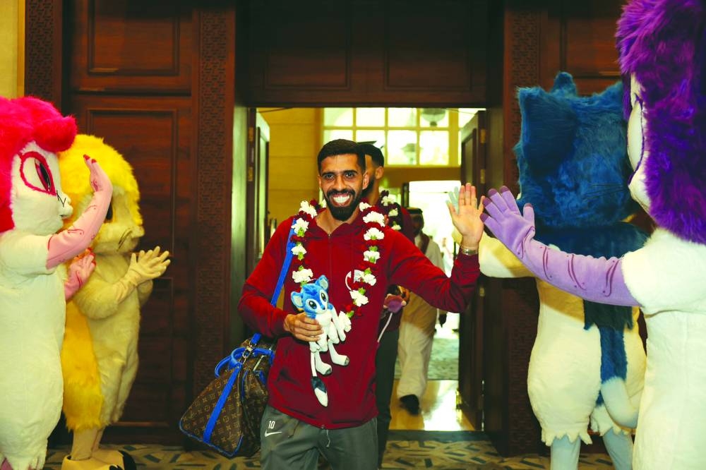 Qatar captain Hassan al-Haydos arrive at the Al Messila resort on Monday.