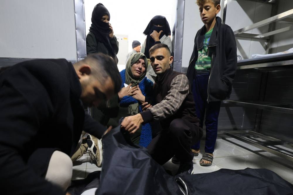 A woman reacts upon identifying the body of a relative from the Abu Naja family, killed during an Israeli strike on Rafah in the southern Gaza Strip on Sunday, at at the morgue of the European hospital in Khan Yunis. AFP