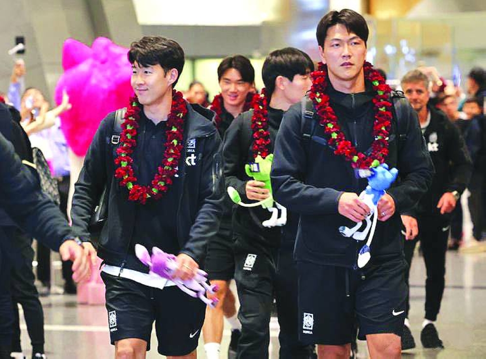 South Korea’s captain Son Heung-min (left) arrives with his teammates at the Hamad International Airport on Wednesday, ahead of the Asian Cup.