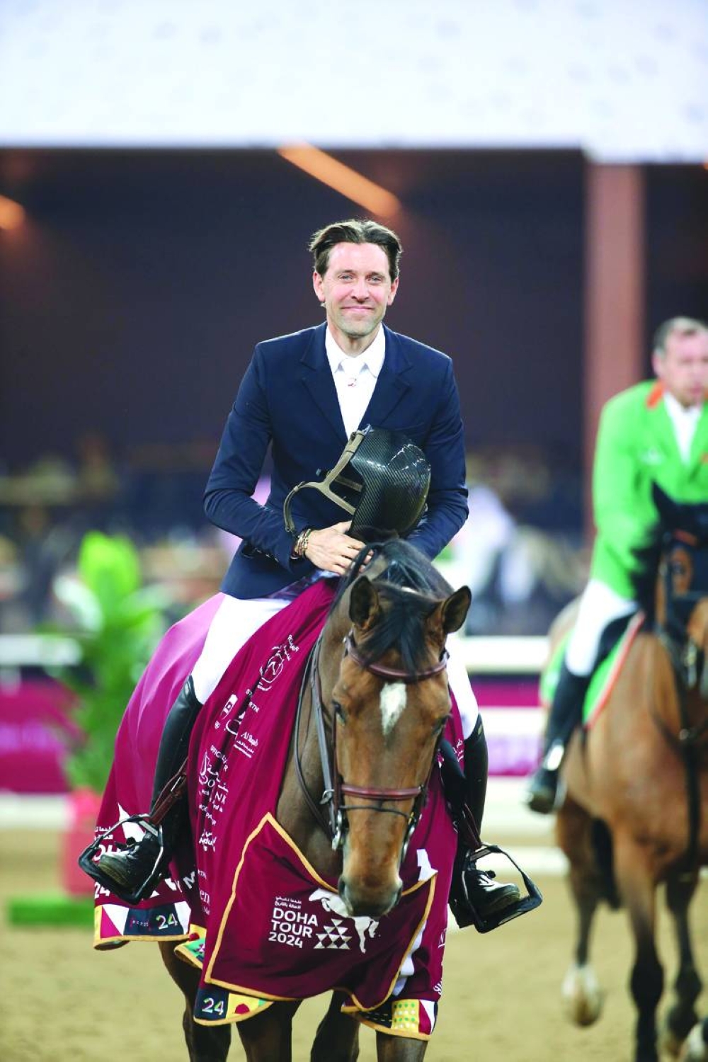 
France’s Simon Delestre celebrates with his 10-year-old bay Olga van de Kruishoeve after the pair won the feature class on the opening day of the Doha International Equestrian Tour Championship. 