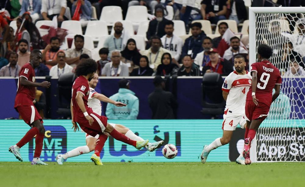 Qatar's Akram Afif scores their first goal. REUTERS