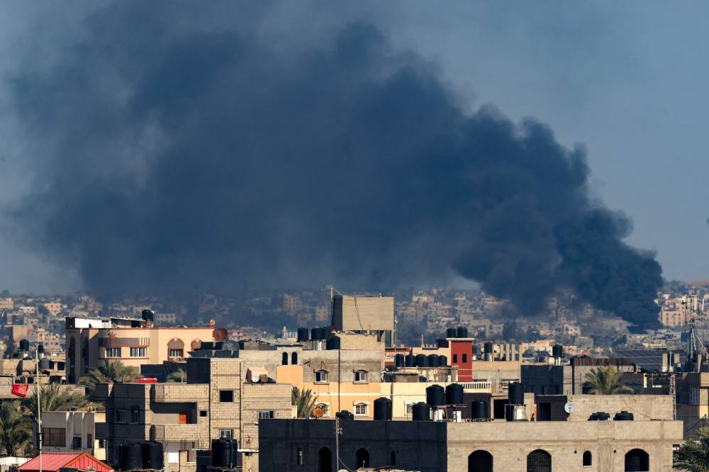 A picture taken from Rafah shows smoke billowing over Khan Yunis in the southern Gaza Strip during Israeli bombardment on Saturday. AFP 