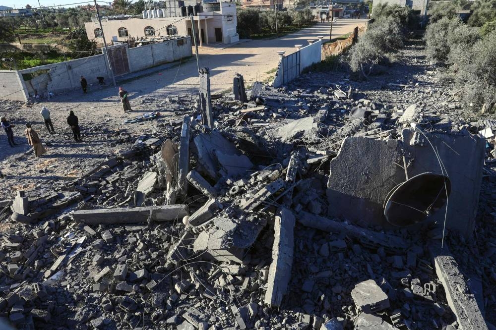 People inspect the damage following Israeli bombardment in Rafah in the southern Gaza Strip on Saturday. AFP 