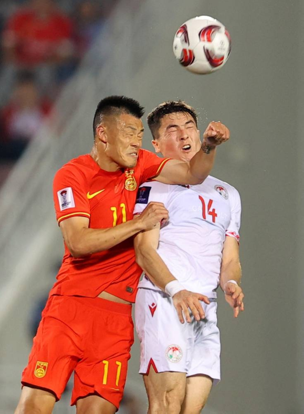 Soccer Football - AFC Asian Cup - Group A - China v Tajikistan - Abdullah bin Khalifa Stadium, Doha, Qatar - January 13, 2024 
China's Long Tan in action with Tajikistan's Alisher Shukurov REUTERS/Ibraheem Al Omari