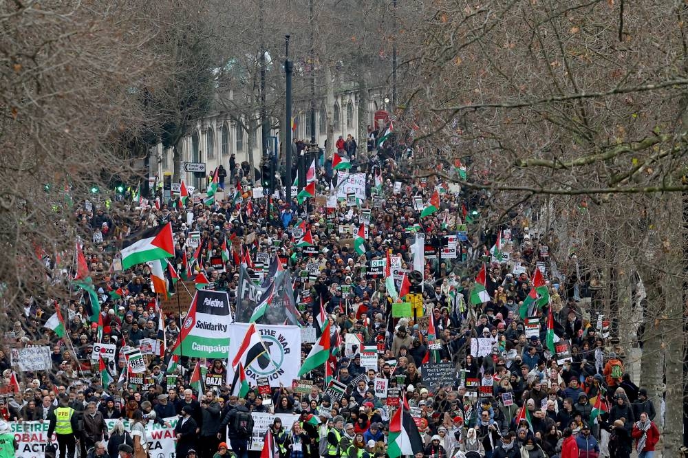 People take part in a protest to mark 100 days since the start of a Israeli attack on Gaza during a "Ceasefire Now/Stop the War in Gaza" protest in London, on Saturday. REUTERS