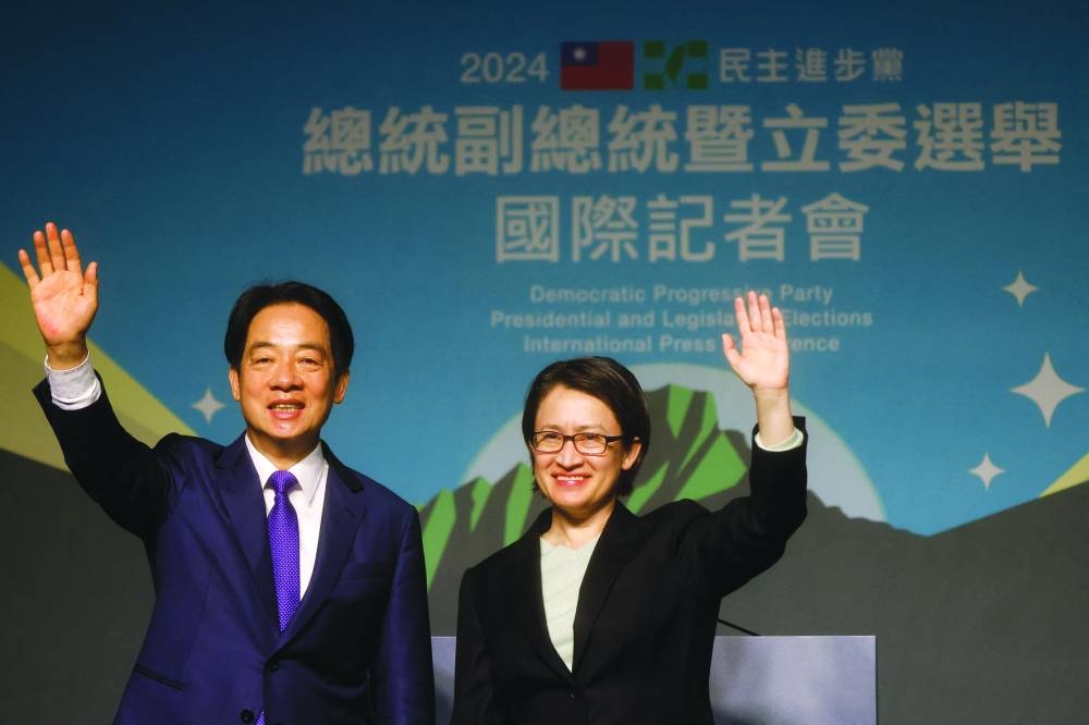 
Taiwan President-elect Lai Ching-te of Democratic Progressive Party and his running mate Hsiao Bi-khim wave as they hold a press conference, following the victory in the presidential elections, in Taipei. 