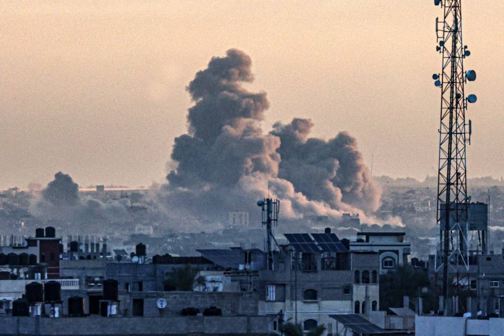A picture taken from Rafah shows smoke billowing over Khan Yunis in the southern Gaza Strip during Israeli bombardment on Sunday. AFP