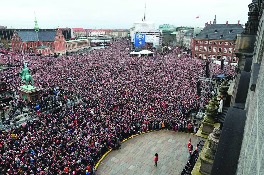 The newly crowned king and queen acknowledge cheers from the crowd. (AFP, Reuters)

