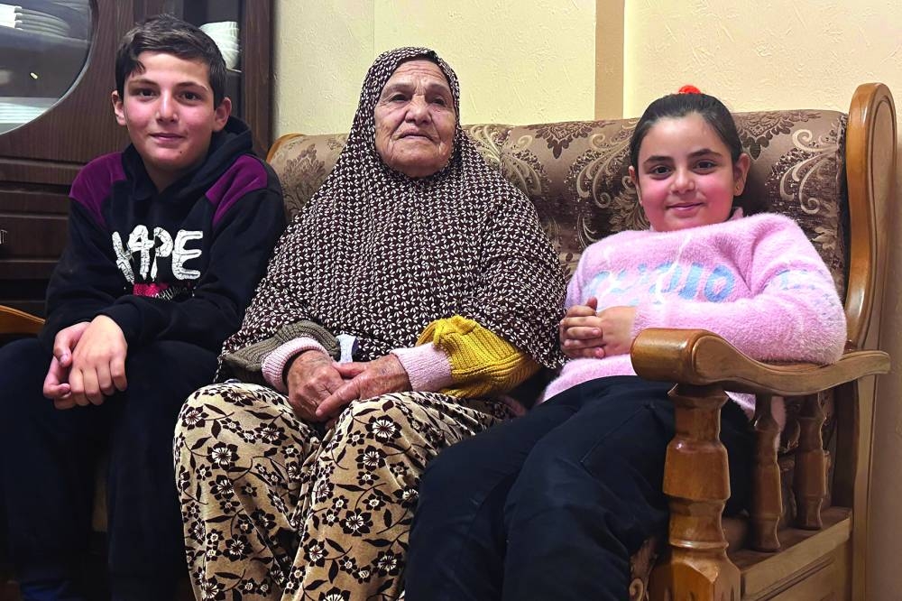 
Rayqa Abu Aweideh, 86, poses with relatives during an interview with AFP journalists at a family house in Rafah refugee camp on the besieged Gaza Strip’s southern border with Egypt. Right: Palestinian elderly woman Liga Jabr, 89, answers journalists’ questions. 