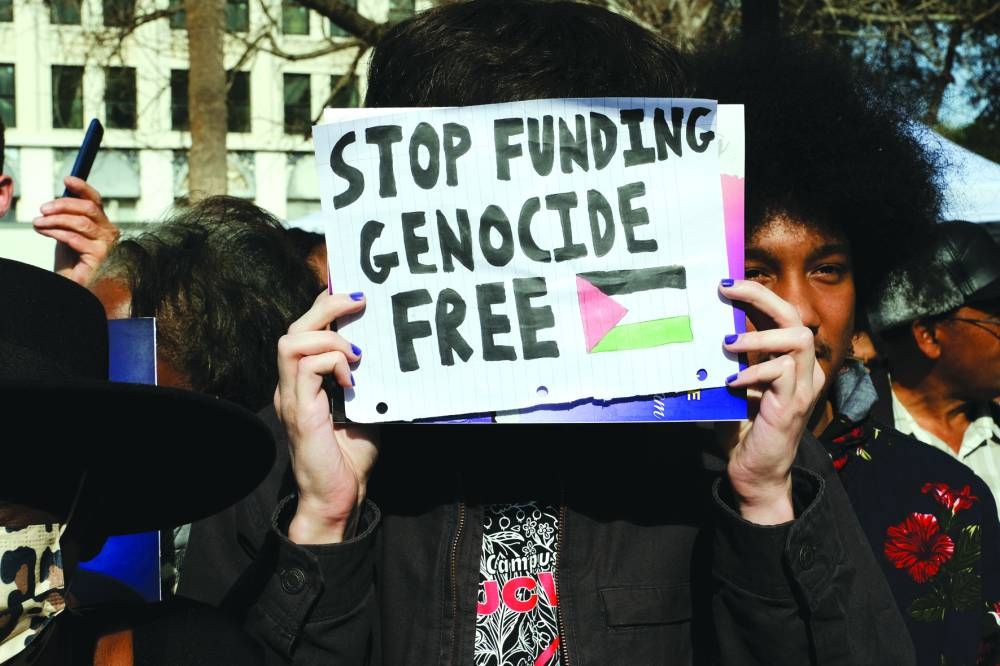 A protester holds a placard as US Vice President Kamala Harris speaks outside the South Carolina State House in Columbia, South Carolina, US, Monday.