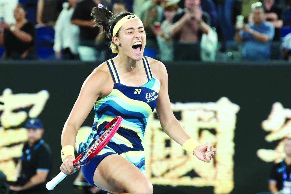 France’s Caroline Garcia celebrates winning against Japan’s Naomi Osaka (right) during their match on day two of the Australian Open in Melbourne on Monday. (AFP)