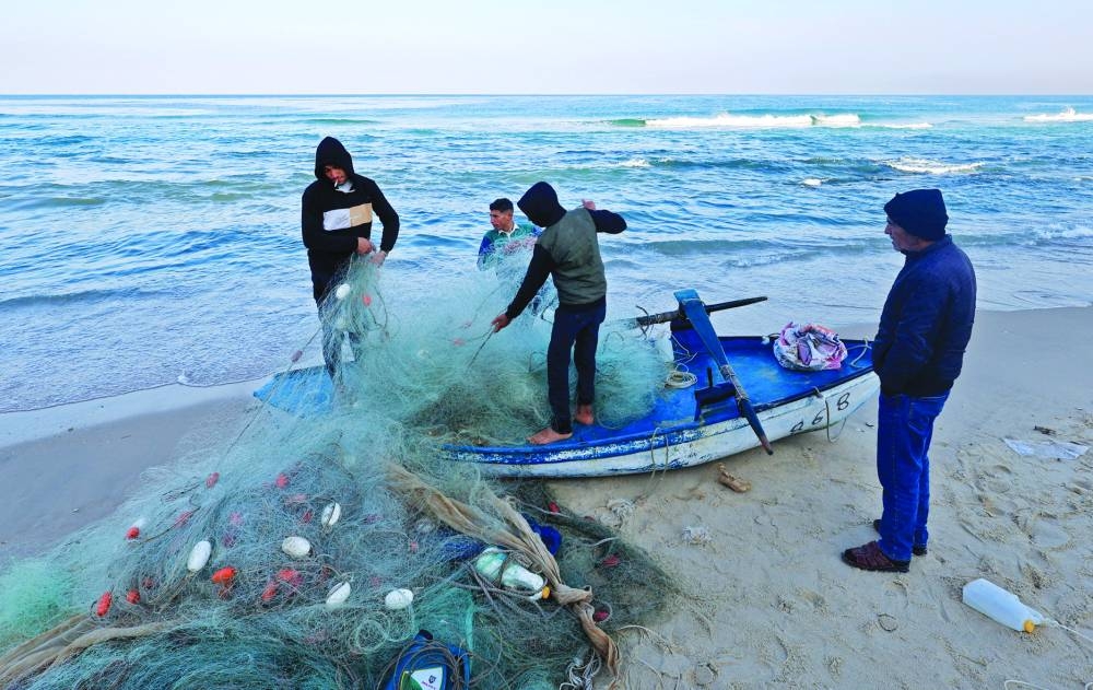 Palestinian fishermen work on the beach, amid the ongoing conflict between Israel and Hamas group, in Rafah, in the southern Gaza Strip.