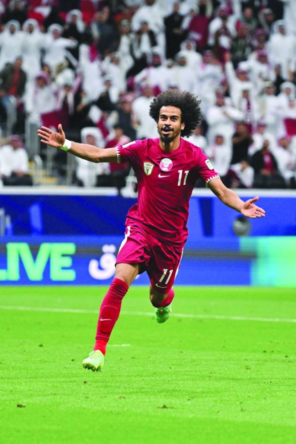 Qatar's forward  Akram Afif celebrates after scoring goal against Tajikistan at the Al Bayt Stadium on Wednesday. (AFP)