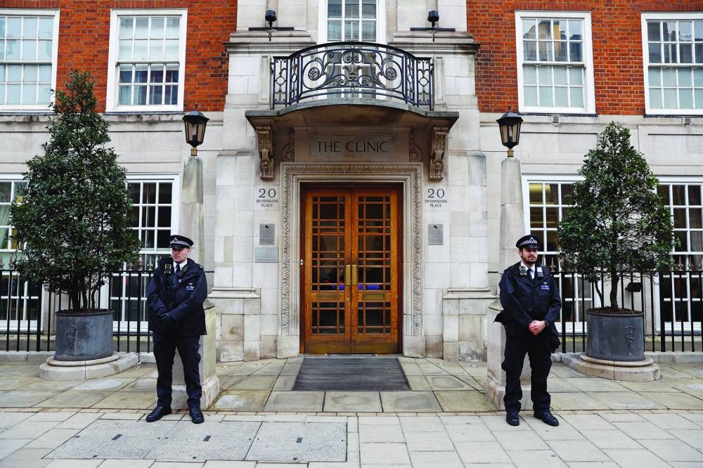 
Police officers stand outside the London Clinic, where Britain’s Catherine, Princess of Wales, is hospitalised for abdominal surgery, in London. 