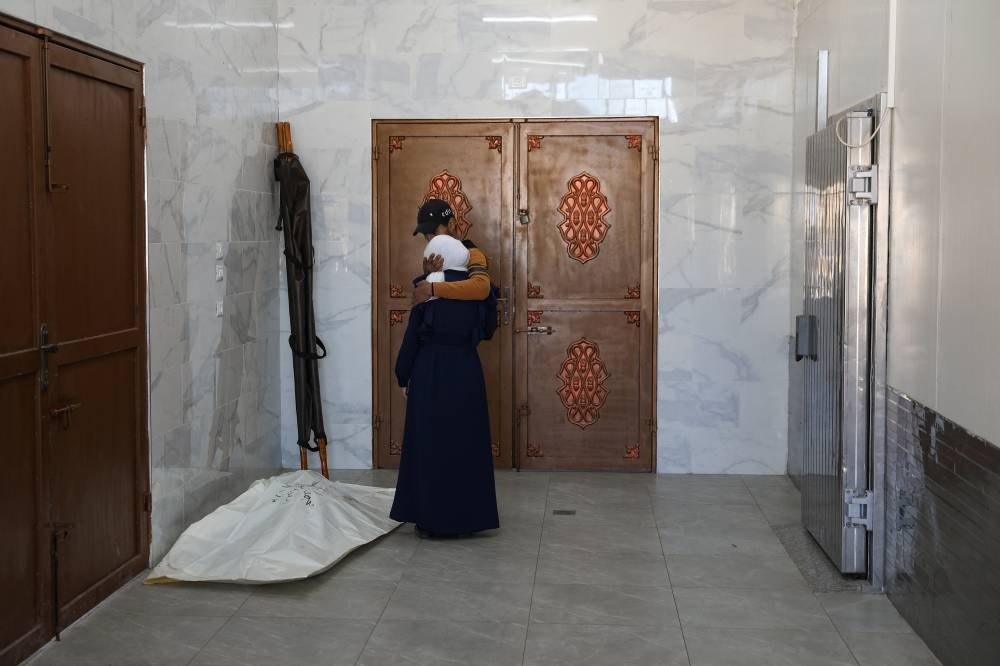 People mourn a Palestinian killed in an Israeli strike at the European hospital in Khan Younis in the southern Gaza Strip, on Thursday. REUTERS
