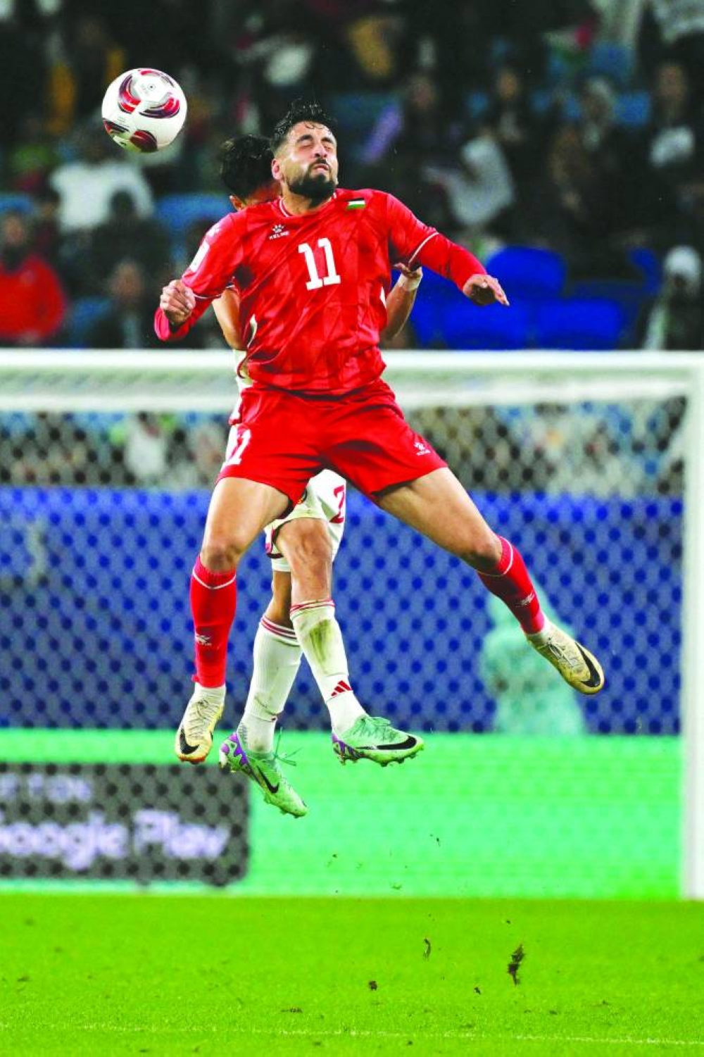 
Palestine’s forward Oday Dabbagh jumps for a header during the Qatar 2023 AFC Asian Cup Group C match against UAE at the Al Janoub Stadium in Al Wakrah, south of Doha, on Thursday. (AFP) 