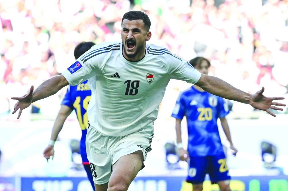 Iraq's forward Aymen Hussein celebrates after scoring during the Asian Cup Group D match against Japan at the Education City Stadium on Friday. (AFP)