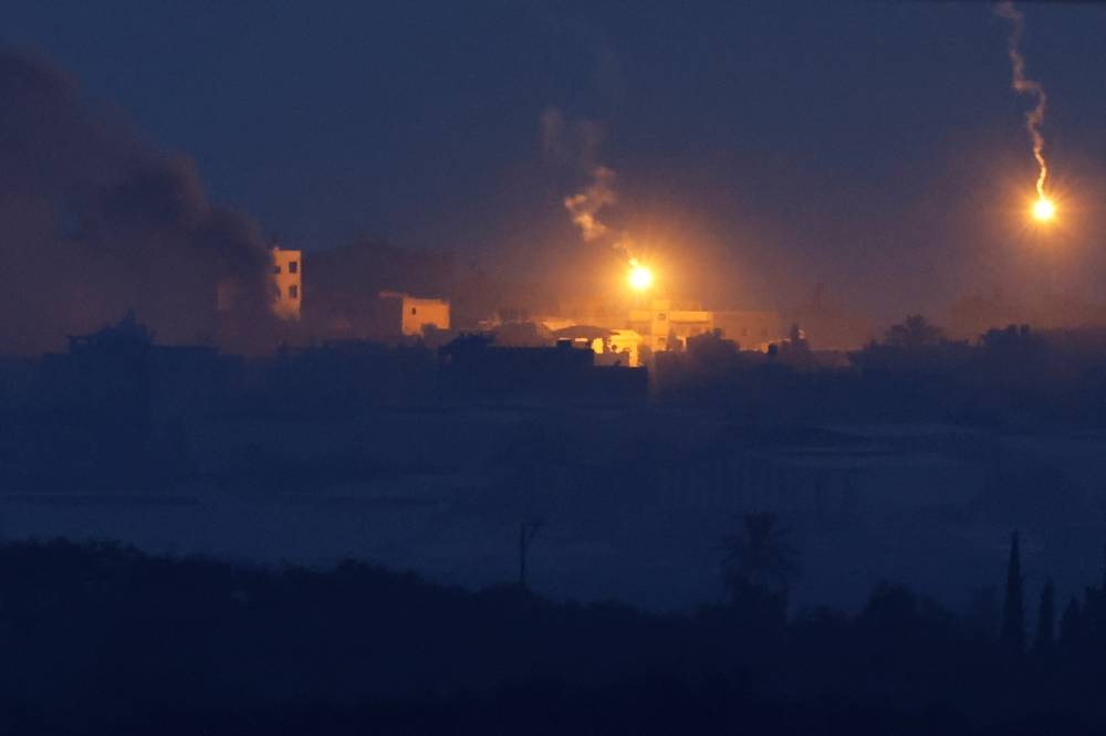 Flares fall over Gaza as seen from Sderot, southern Israel, on Saturday. REUTERS