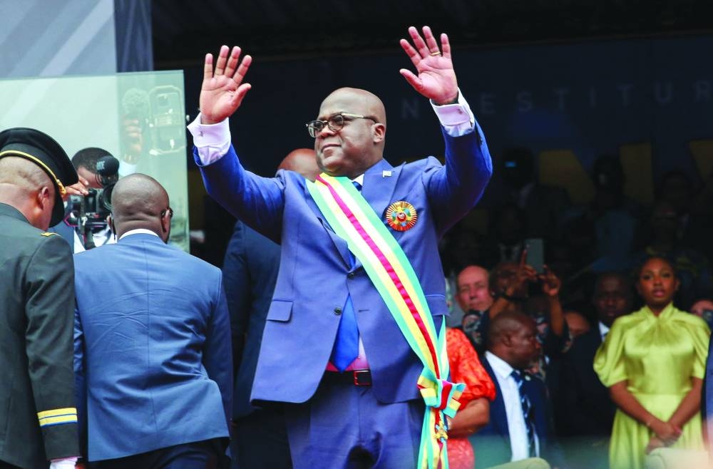 Tshisekedi waves as he arrives to be sworn in for a second term as president during the inauguration ceremony at Kinshasa's Martyrs Stadium.
