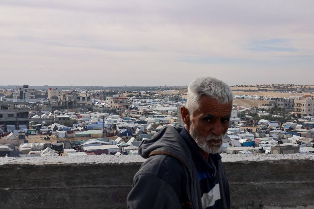 A man looks on near a tent camp where displaced Palestinians, who fled their houses due to Israeli strikes, take shelter, in Rafah in the southern Gaza Strip, Sunday. REUTERS