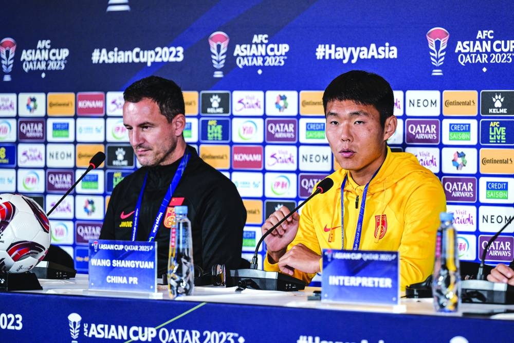 China defender Wang Shangyuan (left)