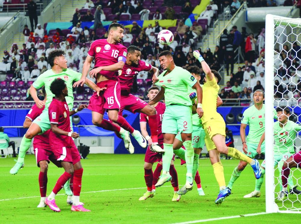 Qatar and China players vie for the ball during the Asian Cup match at the Khalifa International Stadium in Doha on Monday. PICTURE: Shaji Kayamkulam