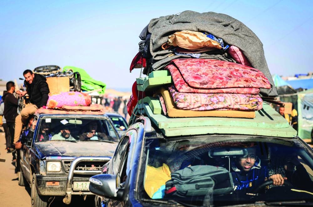 
This photograph taken yesterday on the southern outskirts of Khan Yunis, in the southern Gaza Strip, shows Palestinian families fleeing the city on the coastal road leading to Rafah, amid ongoing battles. 