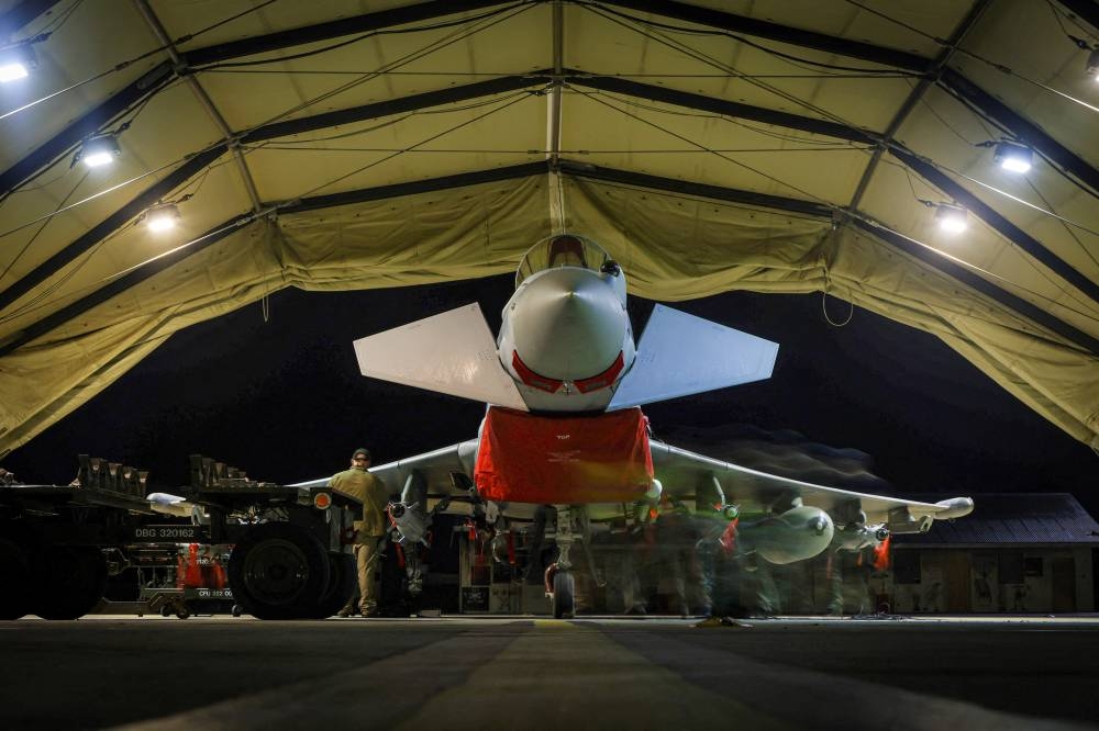 RAF Armourers (Weapon Technicians) prepare a Royal Air Force Typhoon FGR4.Royal Air Force Typhoon aircraft have conducted precision strike operations against Houthi military targets in response to further attacks on shipping in the Red Sea, in this undated handout image. UK MOD/Handout via REUTERS
