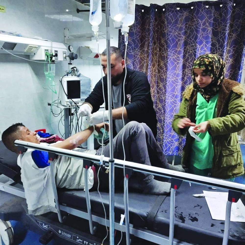 An injured Palestinian man receives medical assistance at Al-Amal Hospital, in Khan Younis, Gaza Strip, Tuesday.