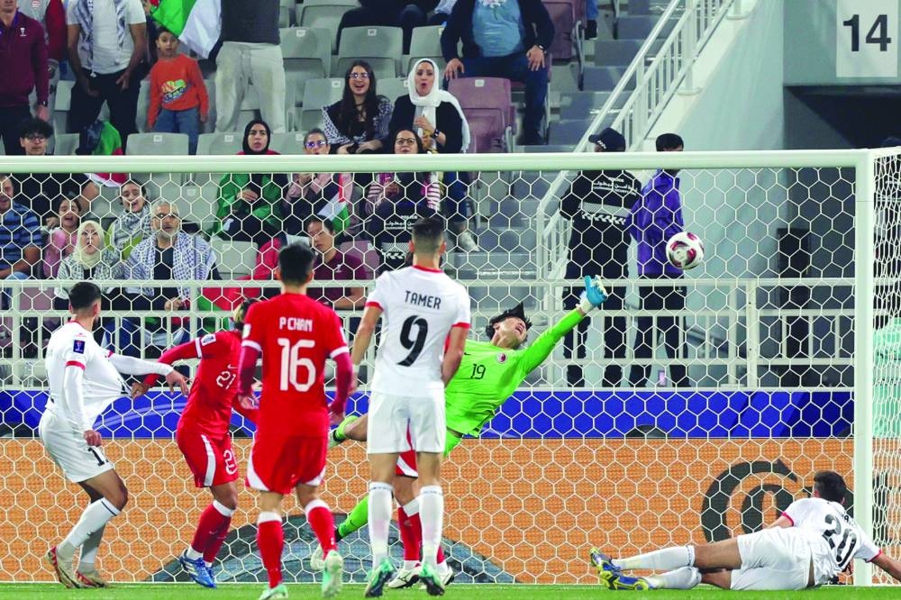 
Oday Dabbagh (left) looks on after heading the ball into the net. (AFP) 