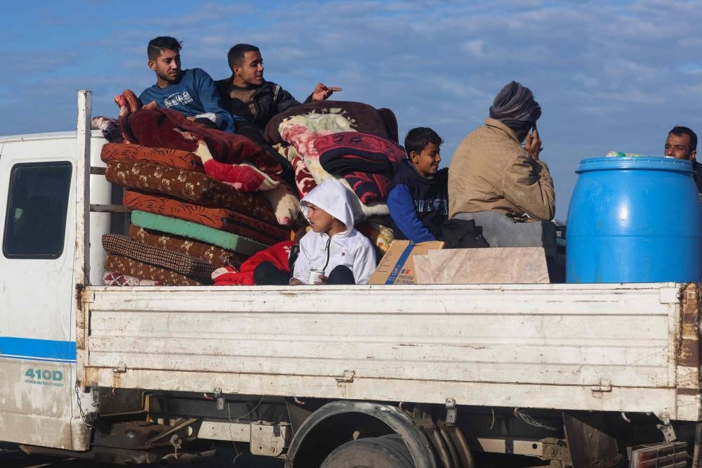 Palestinians arrive from Khan Yunis in a pick-up truck loaded with their belongings, to a a makeshift tent camp for displaced people in Rafah near the border with Egypt in the southern Gaza Strip, on Wednesday. AFP
