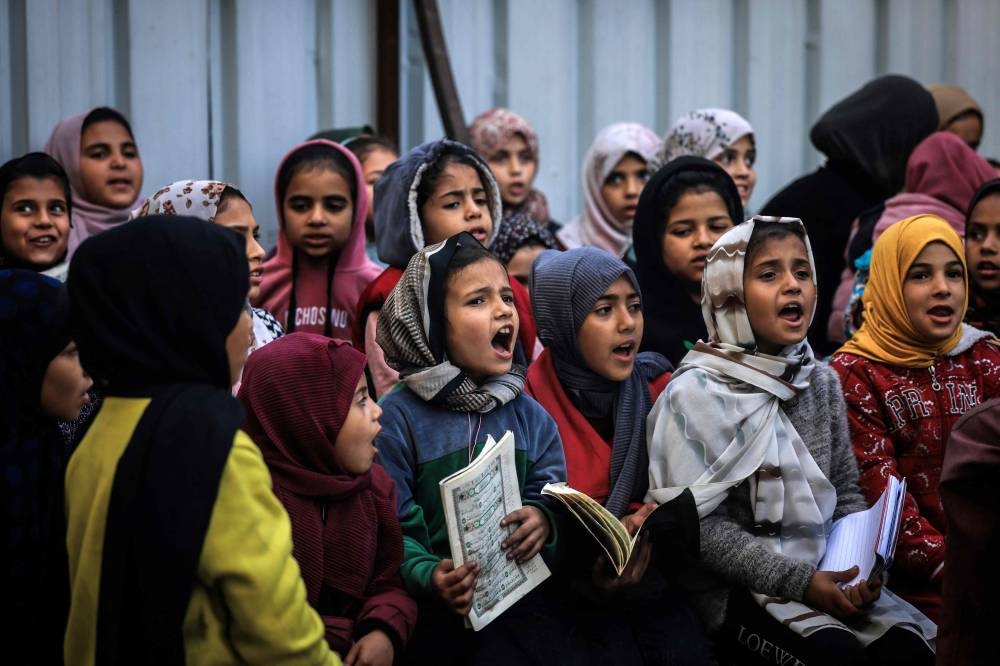 Displaced Palestinian children attend a Quran class at Bear al-Saba school in Rafah in the southern Gaza Strip, on Wednesday. AFP