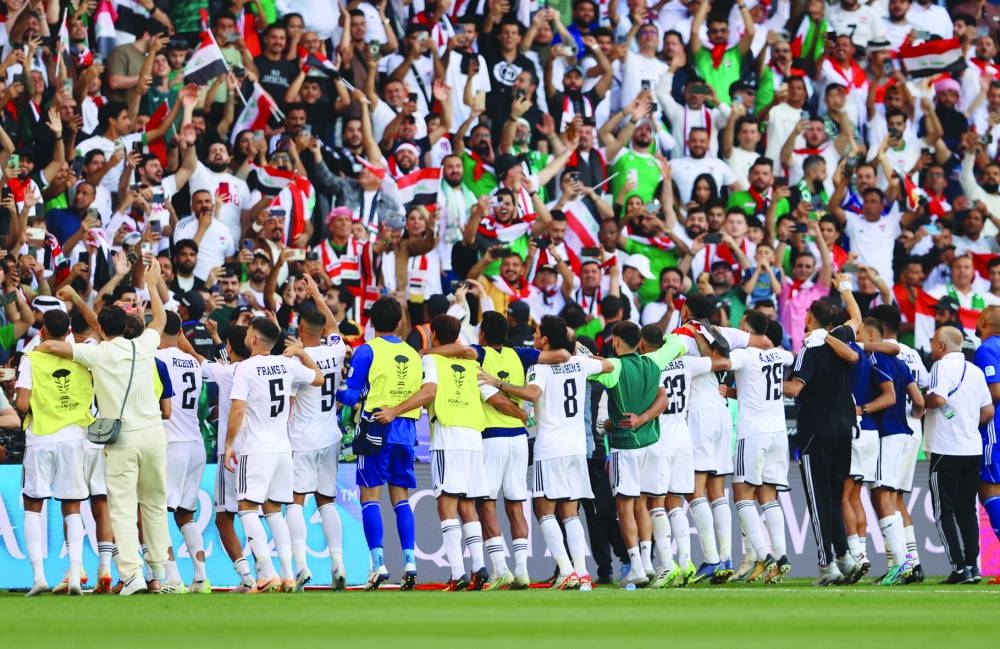 Iraq players celebrate in front of their fans after beating Vietnam in the  Asian Cup at the Jassim Bin Hamad Stadium on Wednesday. (Reuters)