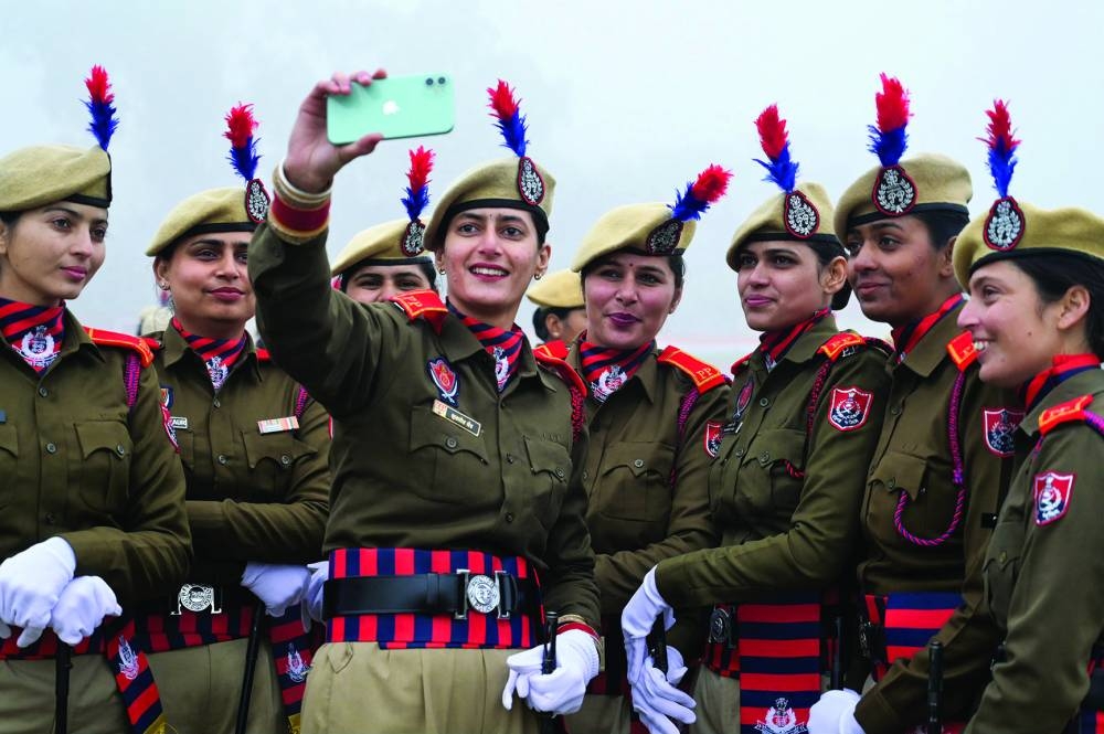 Punjab police personnel takes selfie before they participate in full dress rehearsal for the upcoming Republic Day at the Guru Nanak Stadium, in Amritsar, India, on Wednesday.